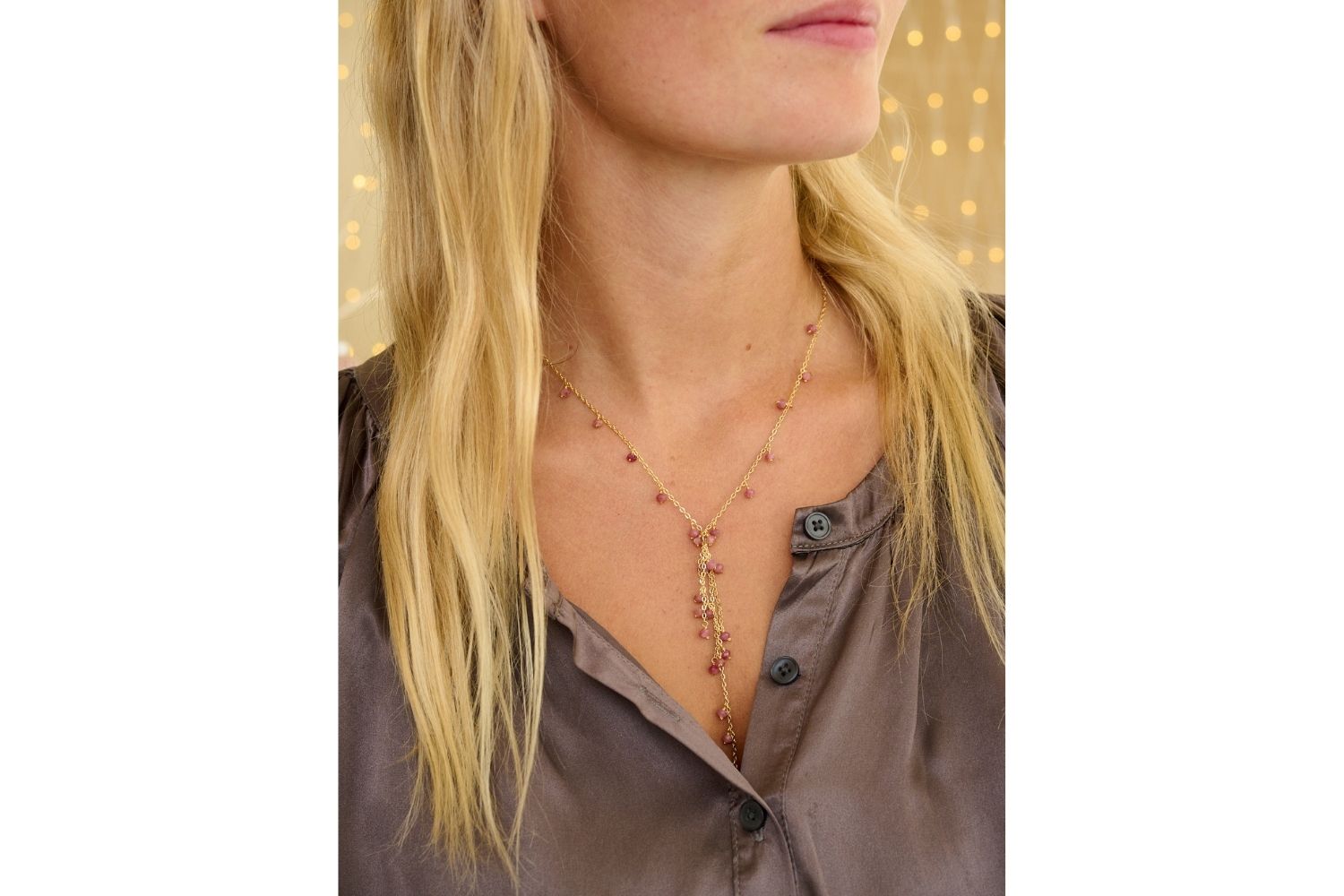 Ivy Pink Tourmaline Lariat Gemstone Necklace styled on model, featuring delicate pink tourmaline gemstones and a 12k gold-plated chain in a chic lariat design.