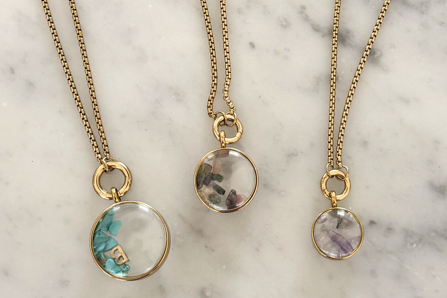 Leilani mini gold locket necklace styled on the neckline, a personalised charm locket perfect for layering and everyday wear.