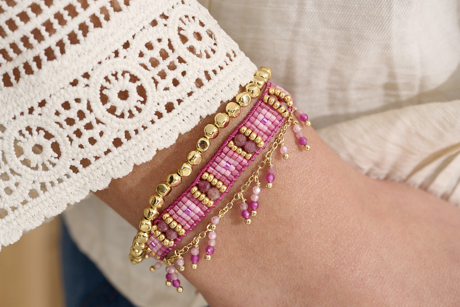 Leilie Pink Tourmaline & Gold Beaded Friendship Bracelet styled on the wrist, showcasing its radiant pink hues, golden accents, and effortlessly chic boho-luxe design.