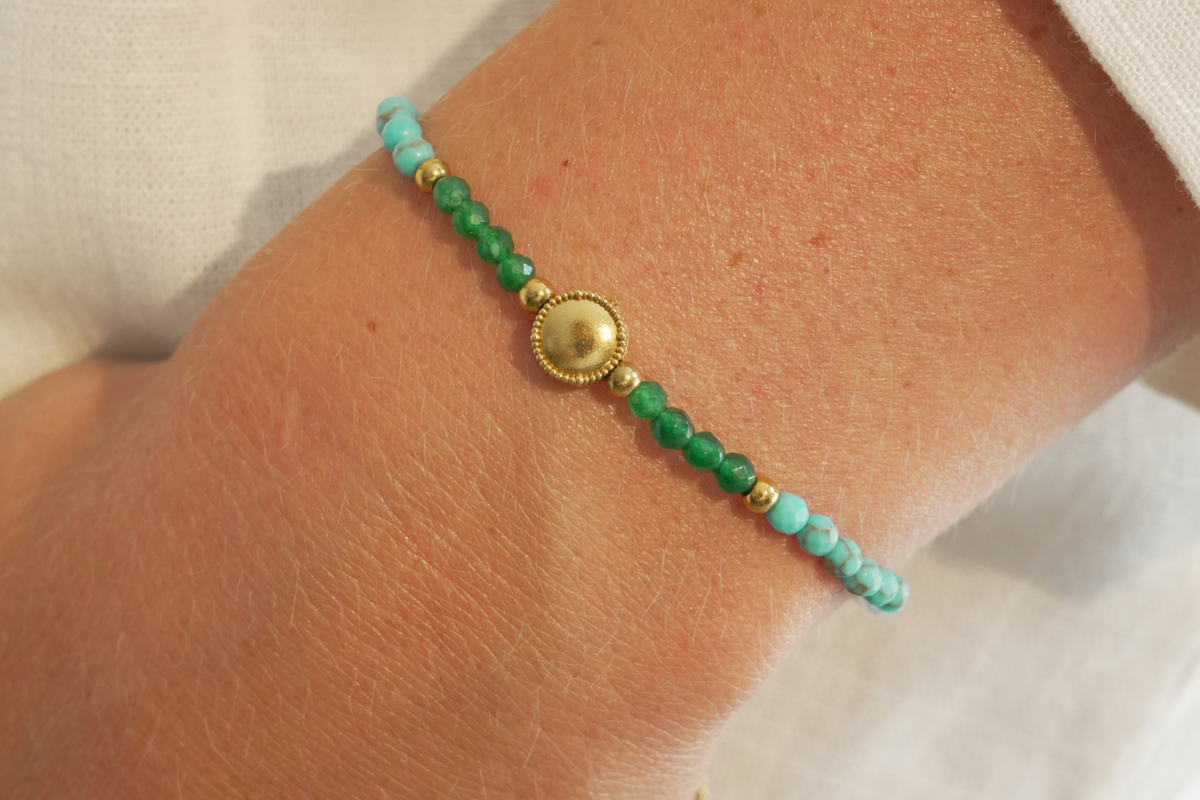 Luana Green Agate Mix Gold Gemstone Slider Bracelet worn on the wrist featuring faceted green agate, amazonite and turquoise howlite gemstones with a waterproof 14k gold PVD slider fastening.
