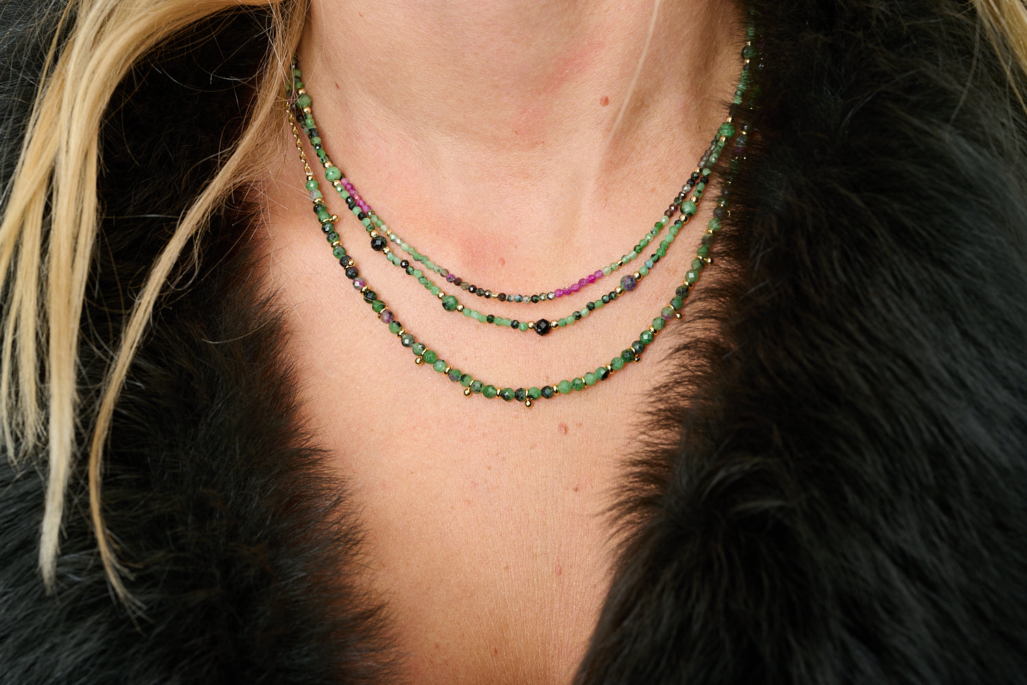 Melrose Ruby Zoisite Necklace styled on neckline with other Boho Betty layering necklaces in a relaxed, boho-chic look.