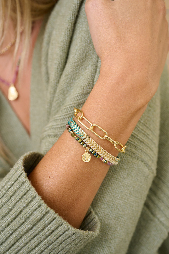 Pamban Gold & Tourmaline Stacking Bracelets styled on the wrist, featuring vibrant tourmaline beads and gold accents. Ideal for layering or gifting.