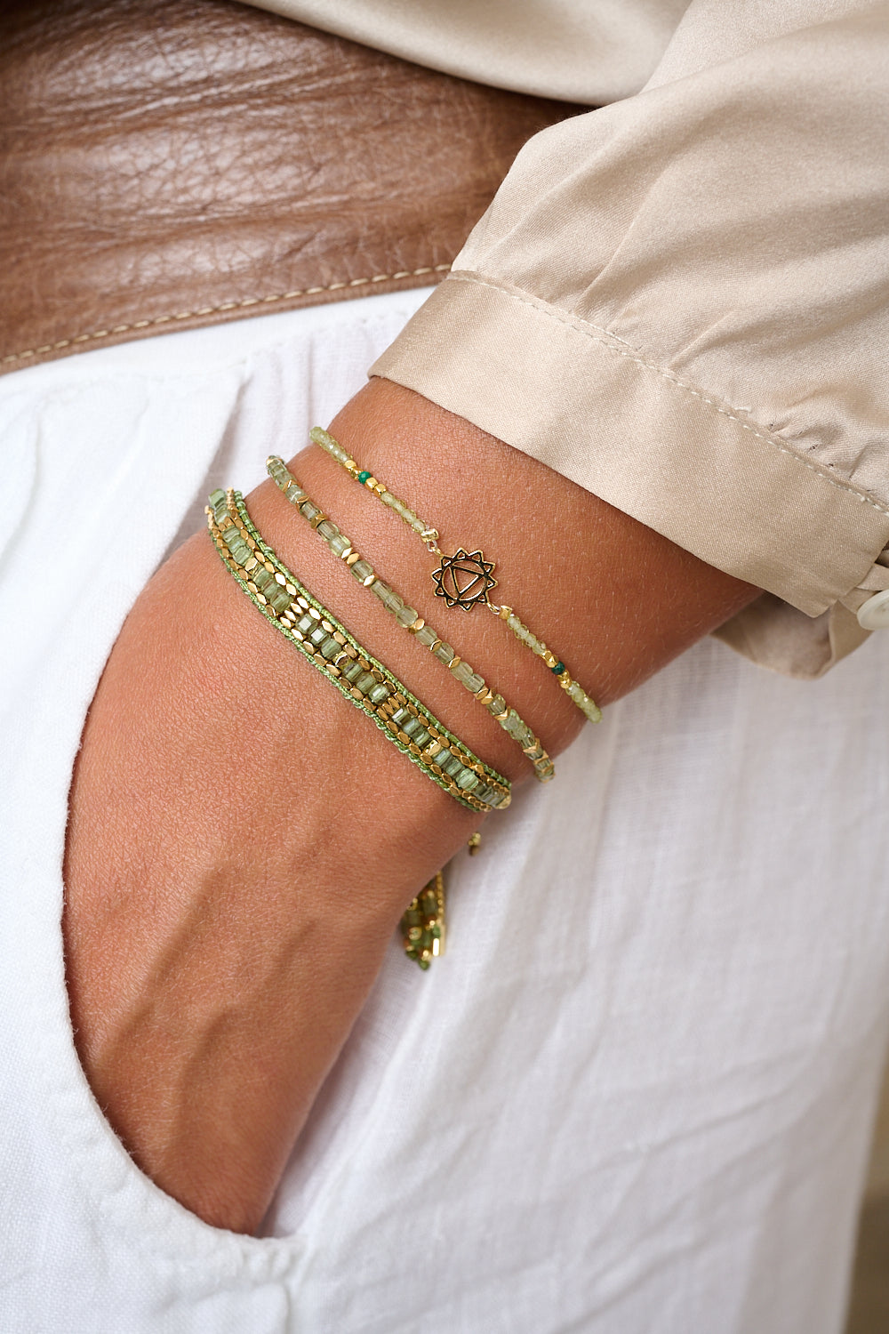 Peridot & Malachite Gold Solar Plexus Chakra Bracelet styled on wrist, showcasing the symbolic Solar Plexus Chakra charm and vibrant gemstone beads.