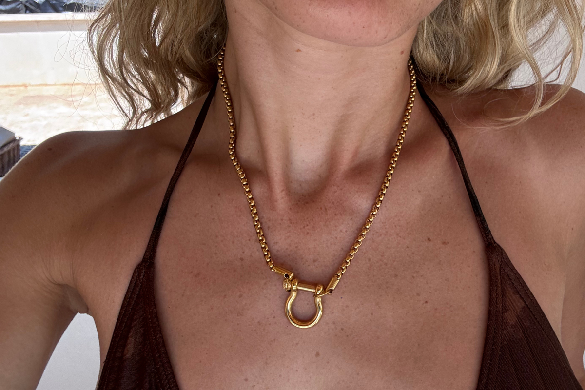 Rosalind Gold Charm Carrier Necklace worn layered with a polished horseshoe charm carrier on a waterproof 14k Gold PVD stainless steel chain, styled with personalised charms.