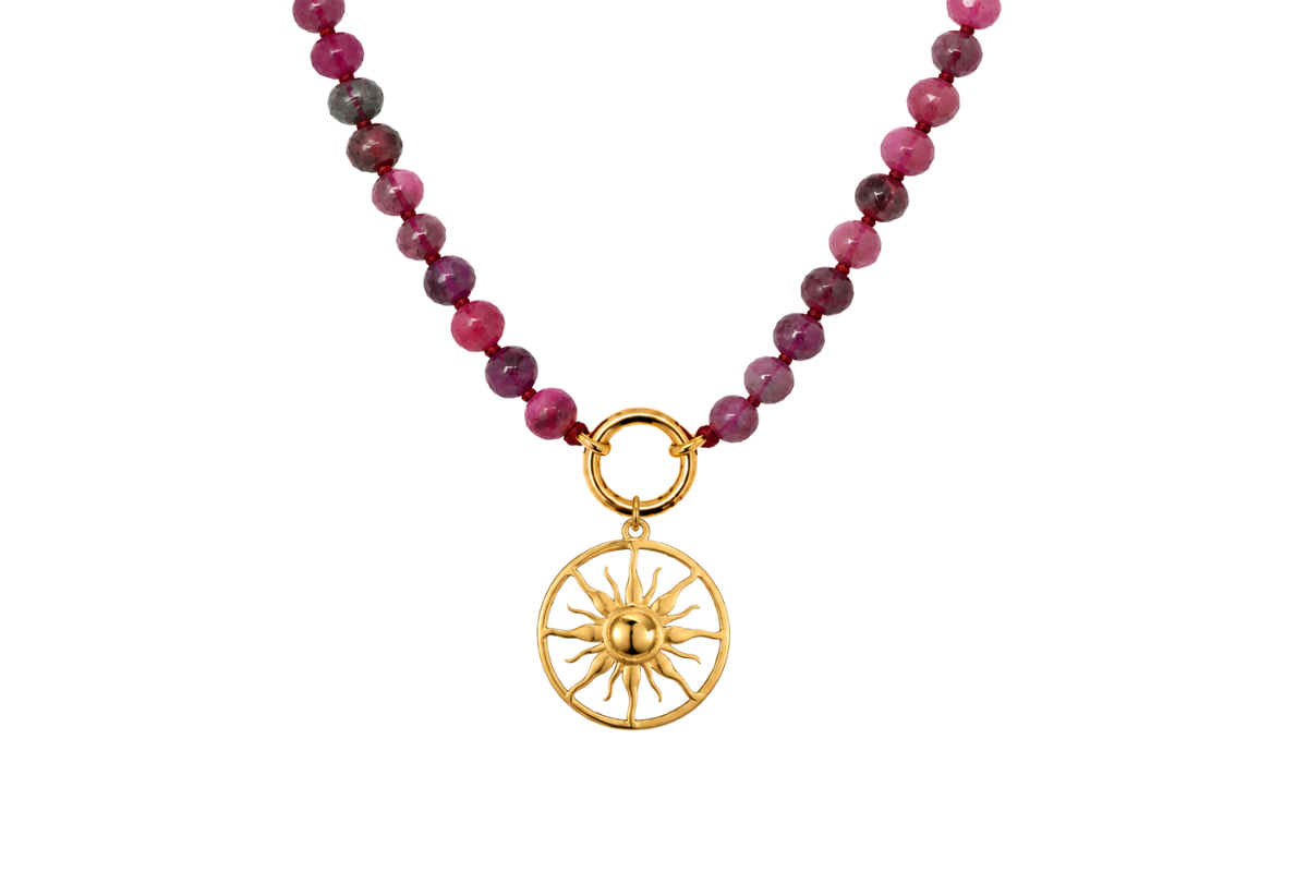 Safa Ruby gold charm carrier necklace finished with the bold gold Sunniva sun charm, a waterproof Boho Betty gemstone necklace.