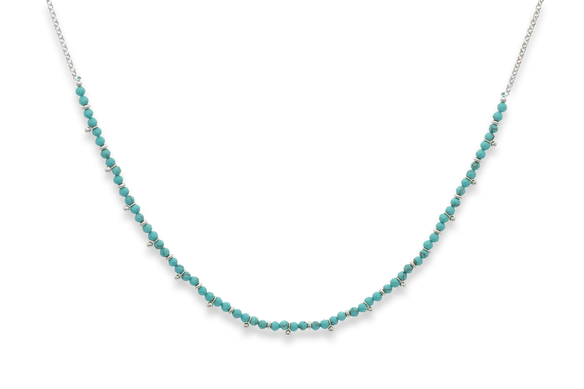 Salus Turquoise Howlite Silver Necklace featuring vibrant turquoise howlite gemstones, waterproof silver PVD stainless steel accents and an adjustable necklace design.