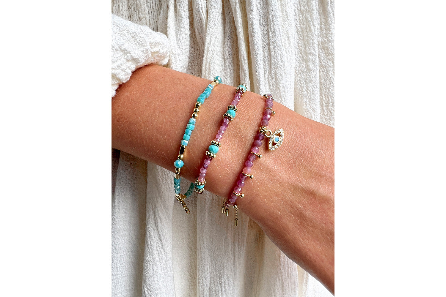 Seraphina Silver & Turquoise Stretch Bead Bracelet styled on the wrist, showcasing shimmering teal and silver tones—perfect for stacking or wearing solo.