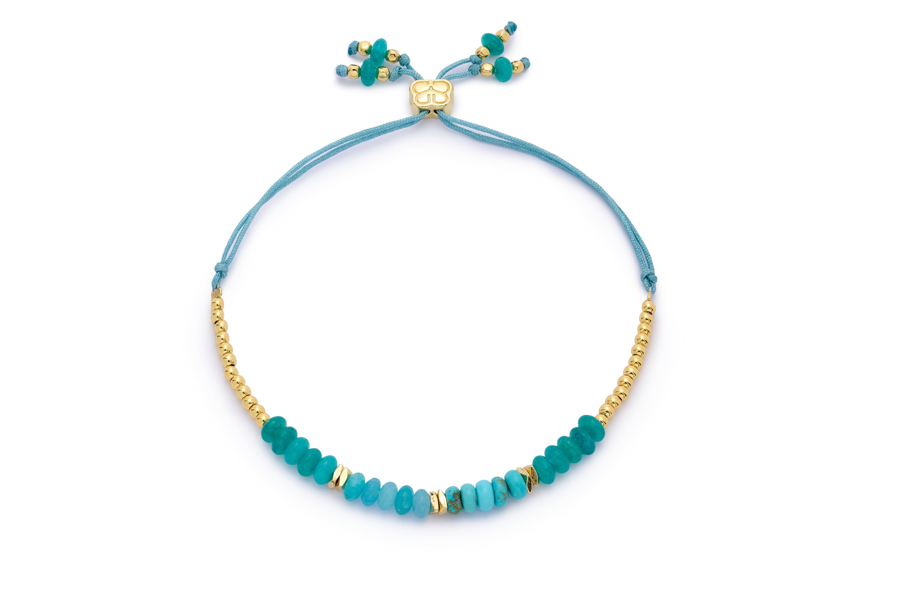 Serena Gold, Turquoise Howlite & Jade Gemstone Bracelet featuring ocean-blue gemstones and gold-plated accents, styled with an adjustable cord design.