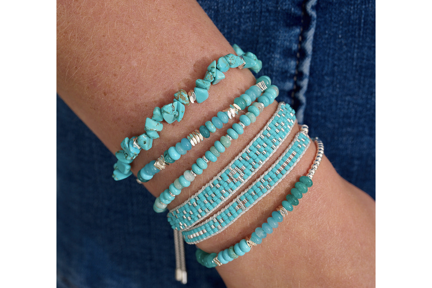 Serena Silver, Turquoise Howlite & Jade Bracelet styled on the wrist, showcasing its delicate beaded design, calming blue and green gemstones, and adjustable slider fastening.