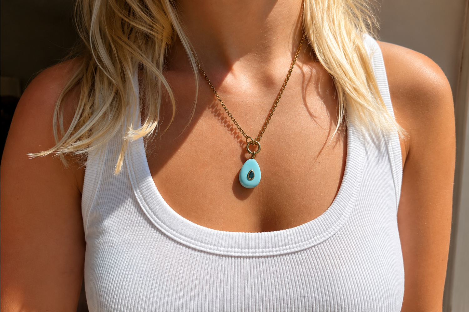 Thalia Long Turquoise Howlite Teardrop Pendant Necklace worn with a turquoise howlite pendant on a long waterproof 14k gold PVD chain for effortless layered styling.