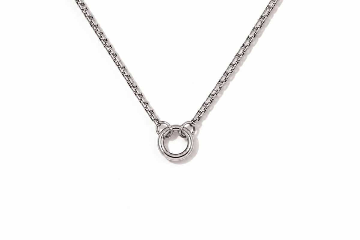 Thalia short silver chain necklace with central ring detail and polished stainless steel finish.