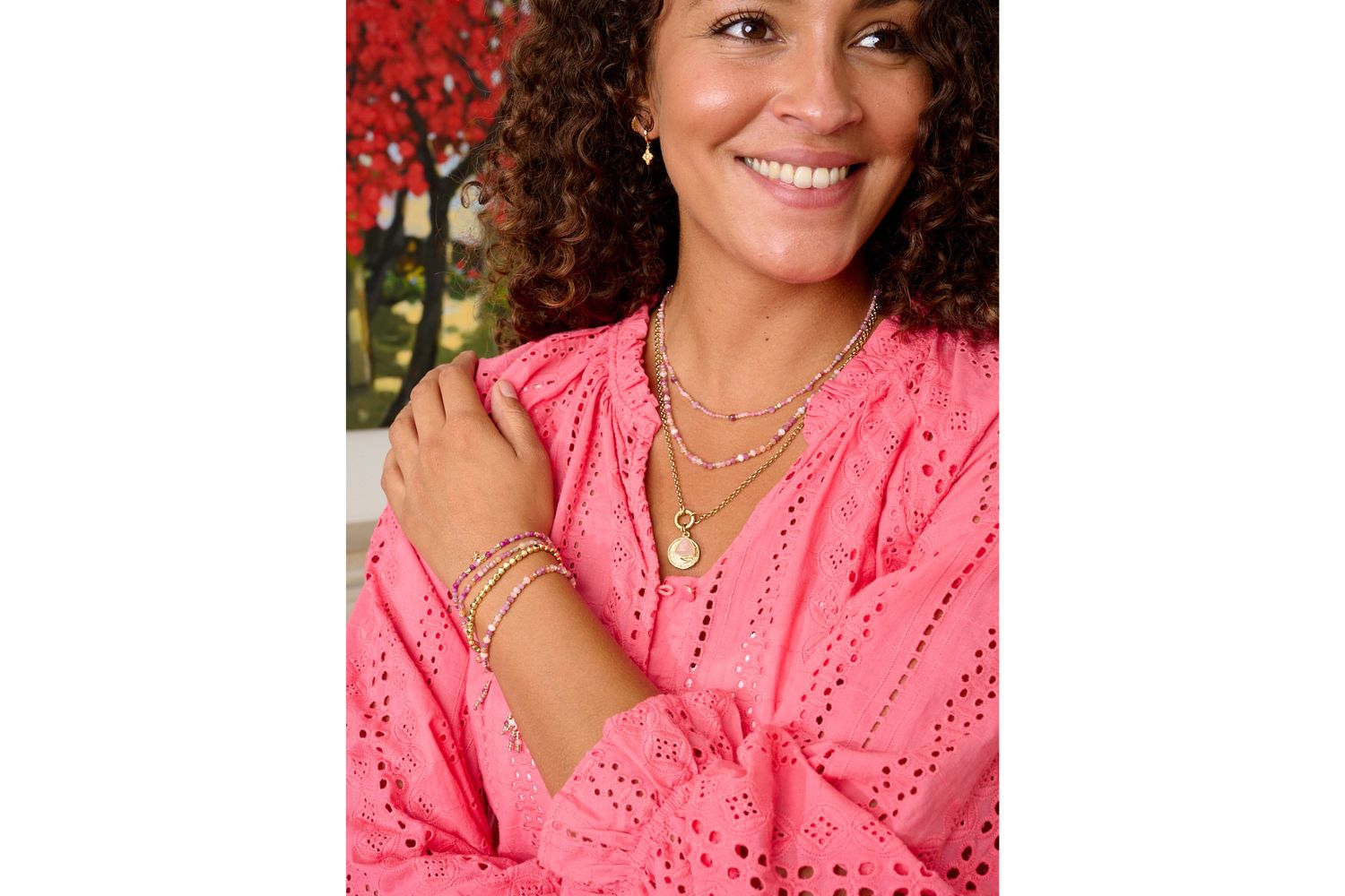 Una Ruby Mix Gold Star Charm Bracelet styled on a wrist, with vibrant ruby hues, golden accents, and a twinkling star charm, perfect for gifting or spiritual stacking.