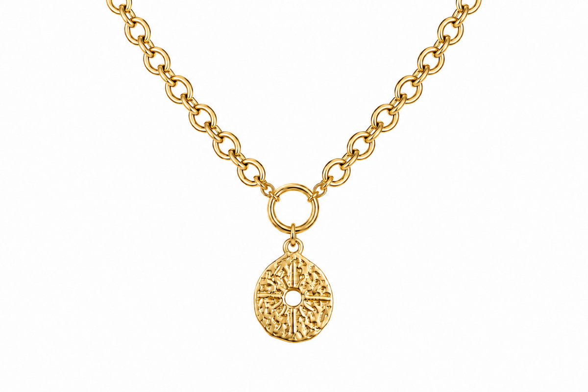 Vela Gold Sunburst Pendant Necklace featuring a textured organic sunburst pendant with a front fastening clasp in waterproof 14k Gold PVD stainless steel.