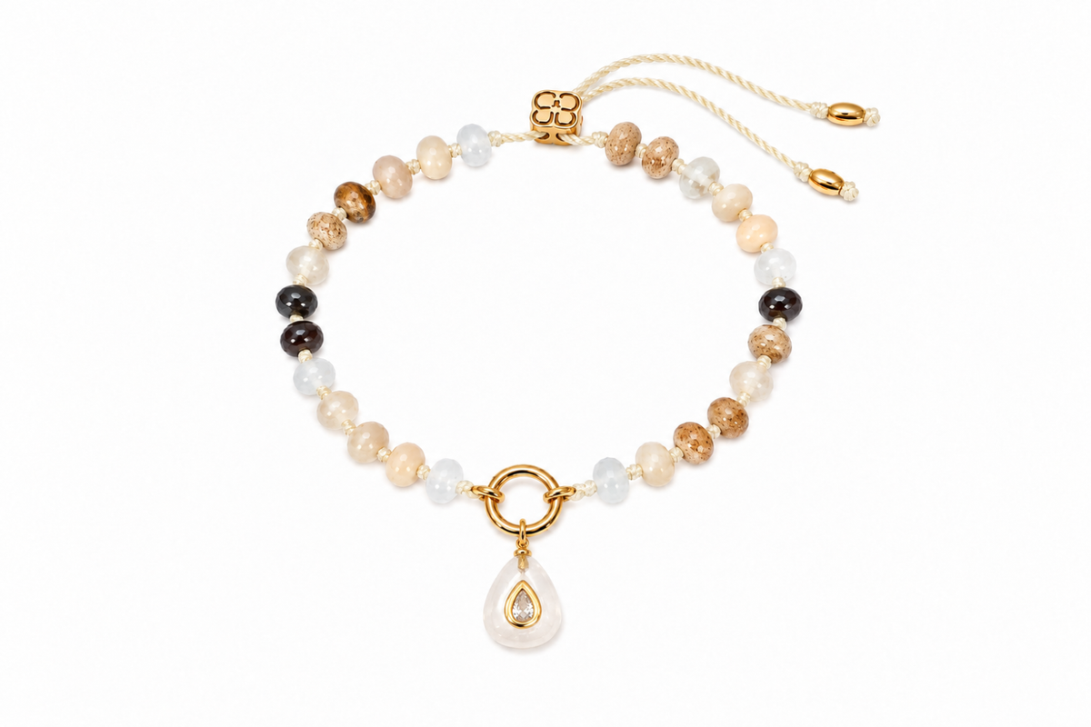 Zaha Brown Mix gold charm carrier bracelet finished with a Fleurette clear quartz teardrop charm, a waterproof Boho Betty gemstone bracelet.