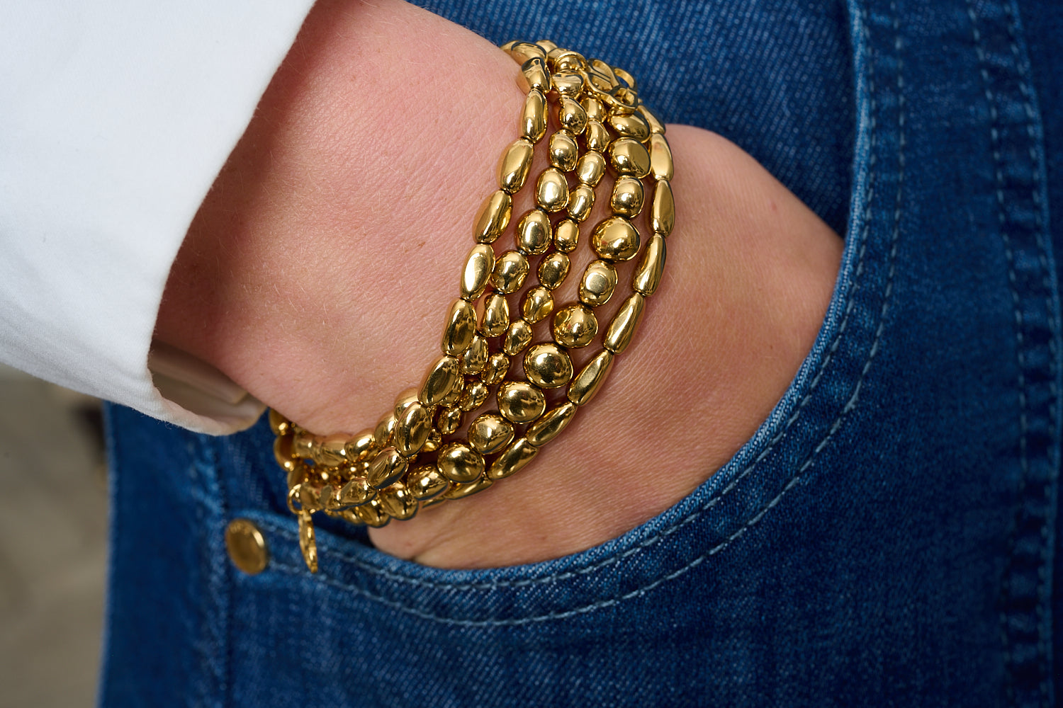 Zarina Gold Bead Stretch Bracelet featured on wrist with Boho Betty stacking bracelets in gold and neutral tones.